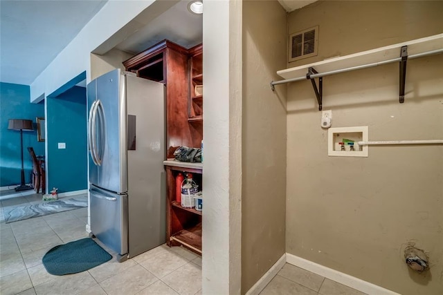 laundry area with light tile patterned floors and hookup for a washing machine