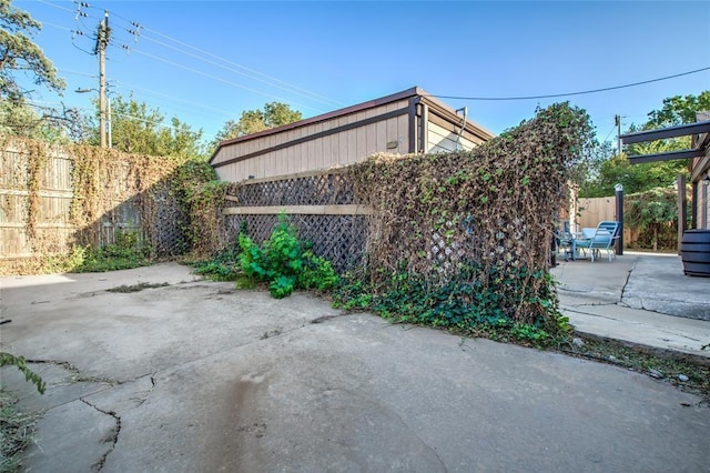 view of side of property with a patio