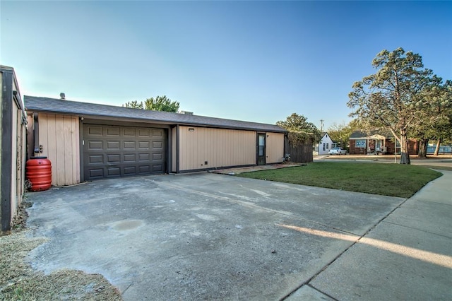 view of front of home with a garage and a front lawn