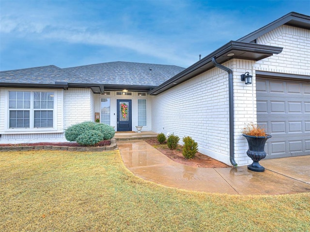 view of front of home with a garage and a front yard