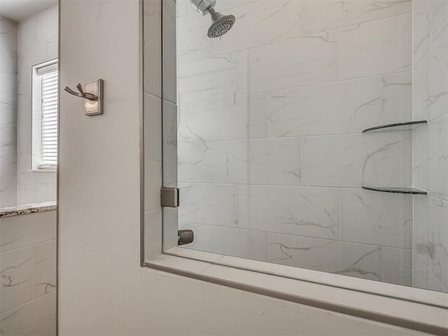 bathroom with a tile shower