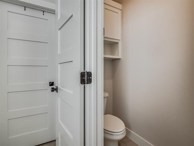 bathroom featuring tile patterned floors and toilet