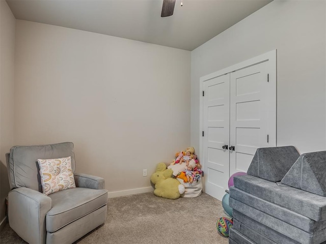 sitting room featuring ceiling fan and carpet