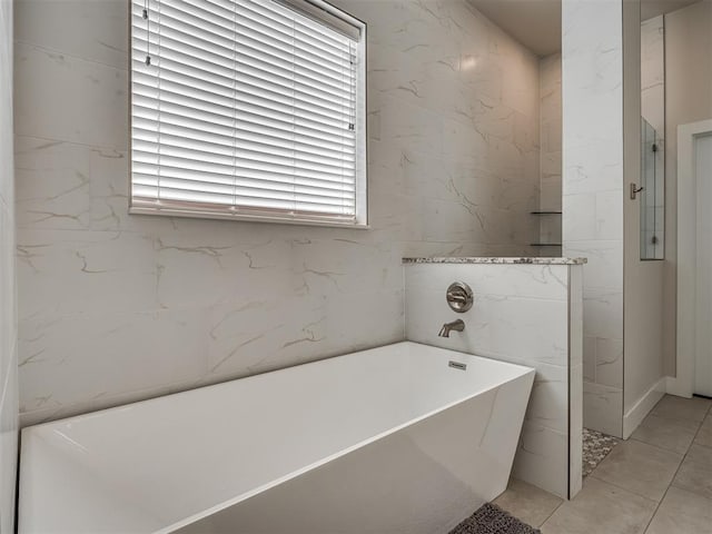 bathroom with a soaking tub and a walk in shower