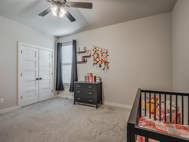 carpeted bedroom featuring a ceiling fan, baseboards, and a closet