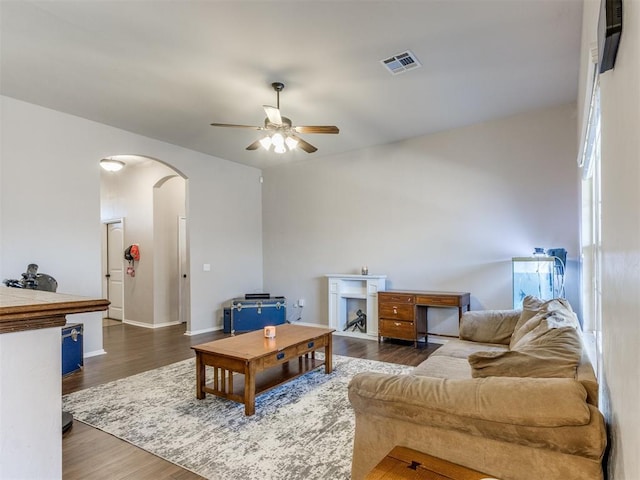 living room featuring dark hardwood / wood-style floors and ceiling fan