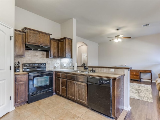 kitchen featuring sink, ceiling fan, black appliances, decorative backsplash, and kitchen peninsula