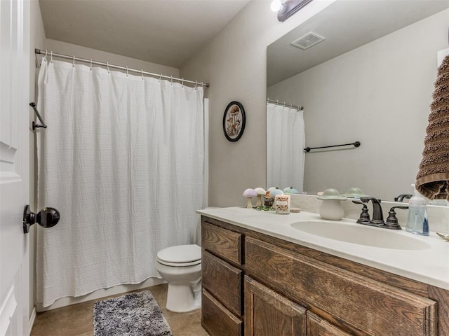 bathroom featuring tile patterned flooring, vanity, and toilet