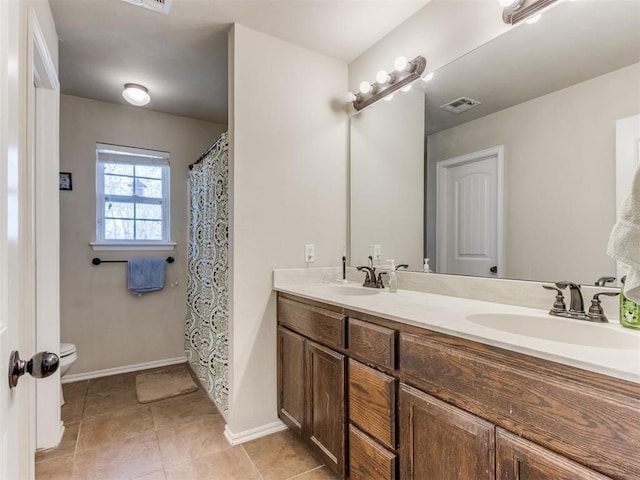 bathroom with vanity, toilet, and tile patterned flooring