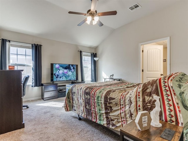 carpeted bedroom with ceiling fan and lofted ceiling