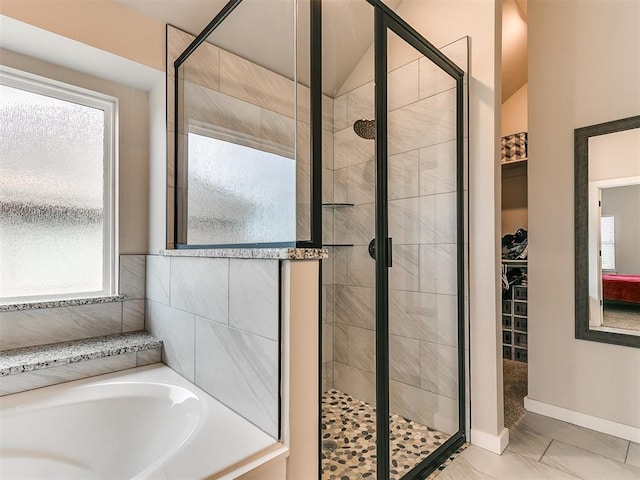 bathroom with vaulted ceiling and separate shower and tub