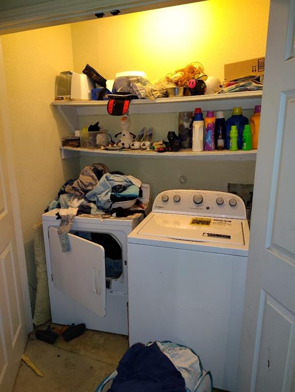 clothes washing area featuring separate washer and dryer