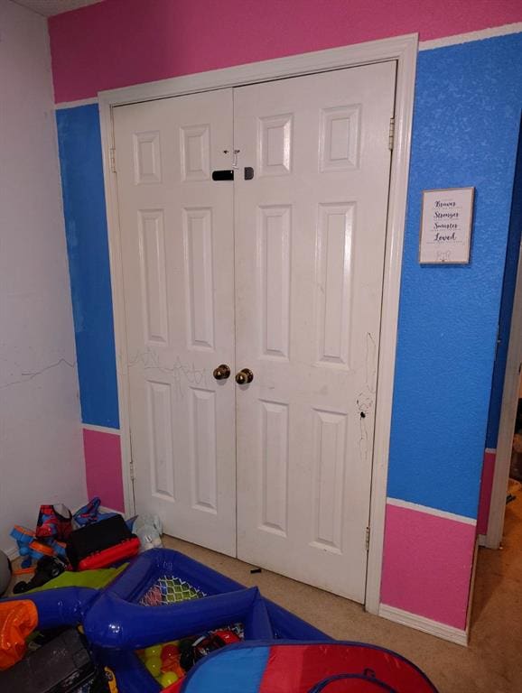 carpeted bedroom featuring a closet