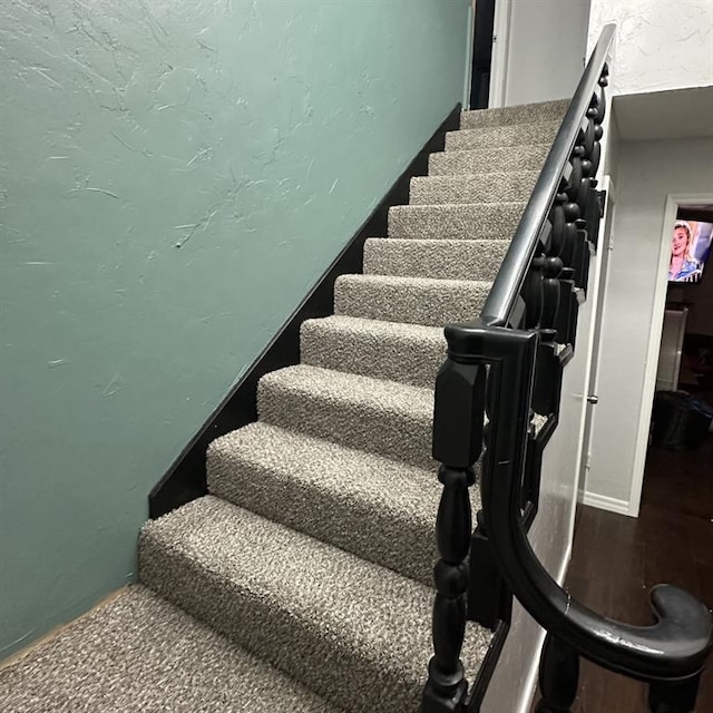 stairway featuring wood-type flooring