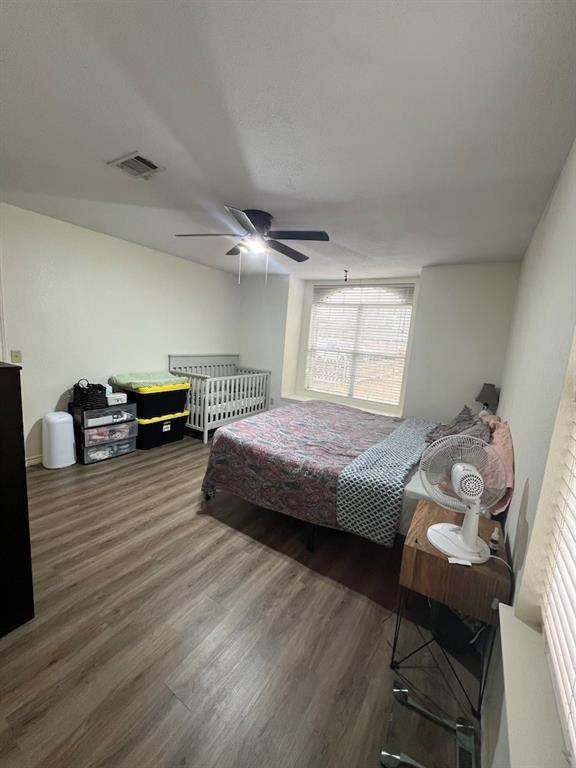 bedroom with dark wood-type flooring and ceiling fan