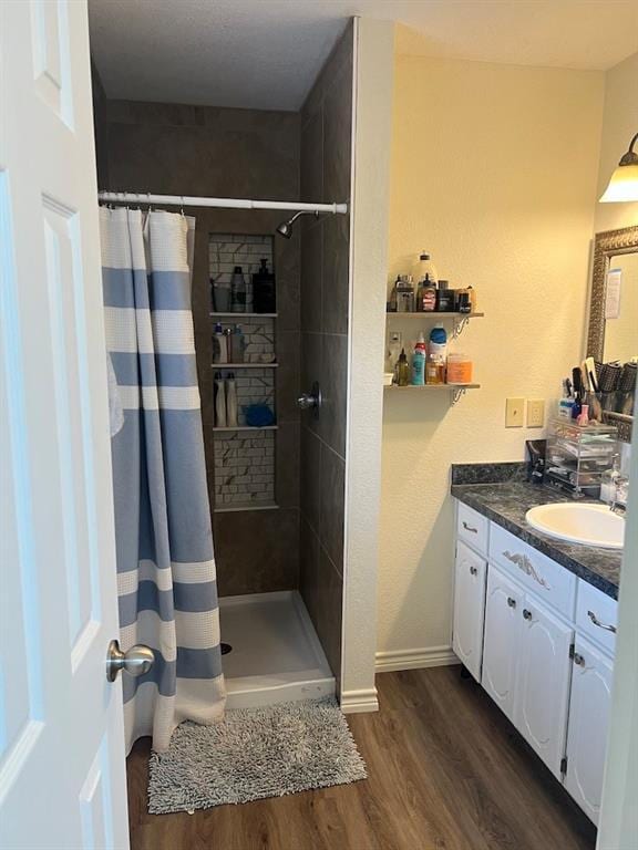 bathroom featuring vanity, curtained shower, and hardwood / wood-style floors