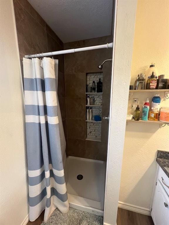 bathroom with vanity, a shower with curtain, and hardwood / wood-style flooring