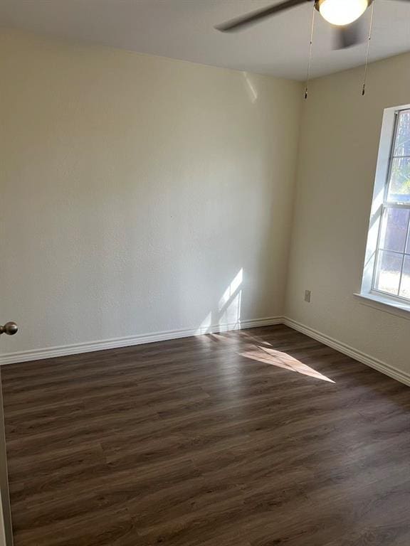 unfurnished room featuring dark hardwood / wood-style flooring and ceiling fan