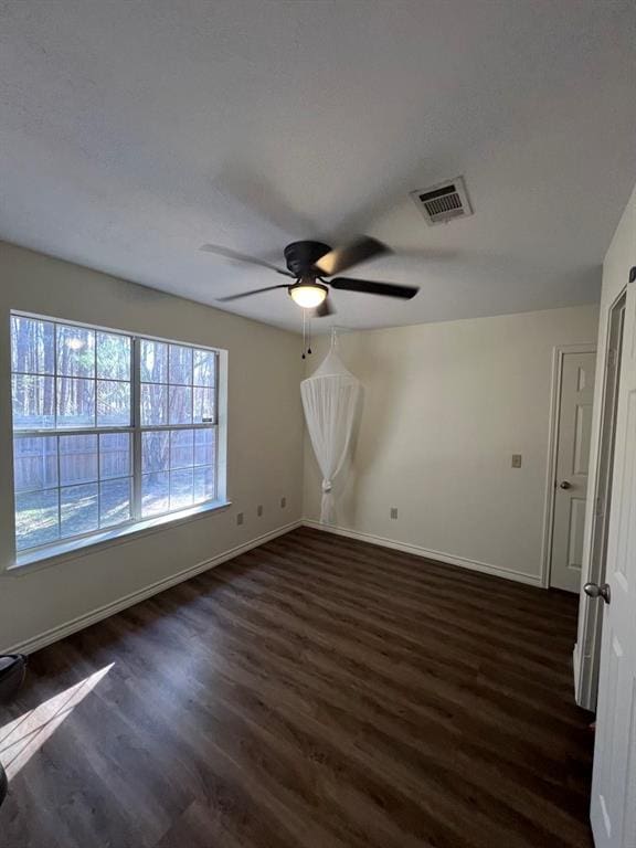 interior space with dark wood-type flooring and ceiling fan