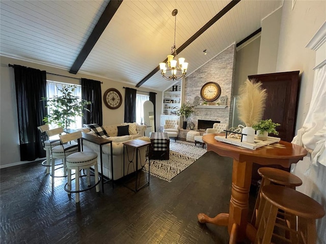 living room featuring a stone fireplace, beamed ceiling, dark hardwood / wood-style flooring, a notable chandelier, and built in shelves