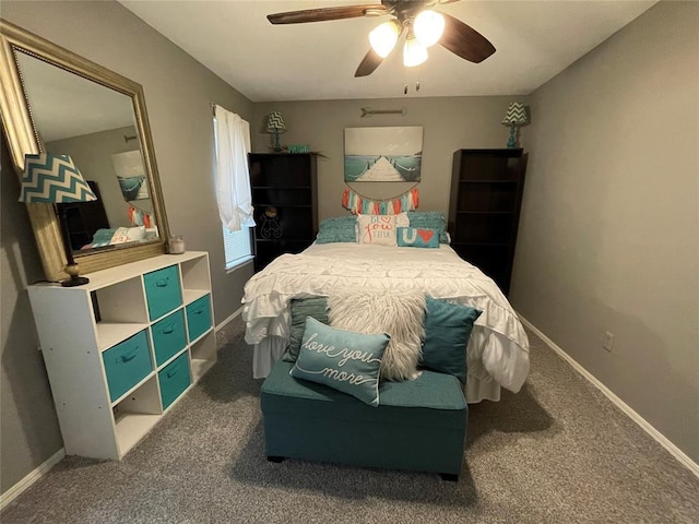 bedroom with ceiling fan and dark carpet