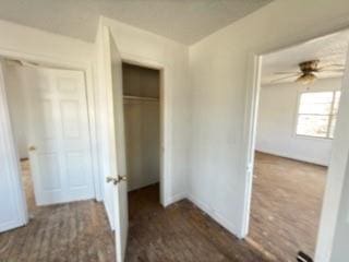 unfurnished bedroom featuring ceiling fan and dark hardwood / wood-style floors