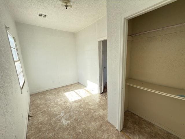 unfurnished bedroom featuring a textured ceiling