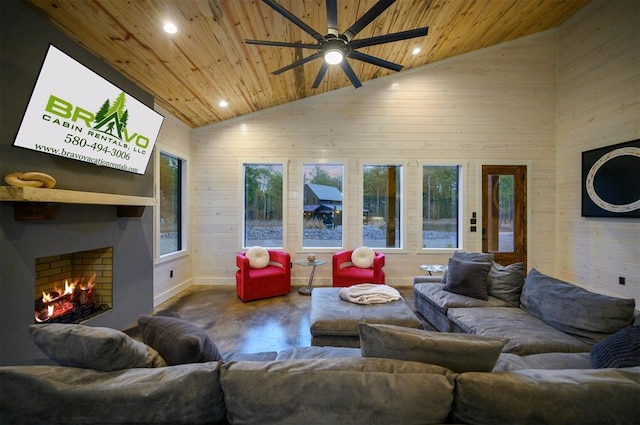 living room with wood ceiling, high vaulted ceiling, a large fireplace, and wood walls