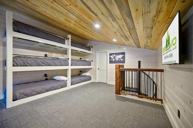 unfurnished bedroom with wood walls, lofted ceiling, carpet flooring, and wooden ceiling