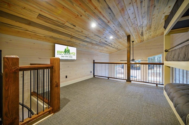 additional living space with wood ceiling, vaulted ceiling, wooden walls, and carpet flooring