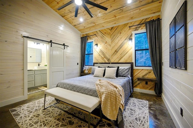 bedroom featuring vaulted ceiling, wood walls, a barn door, wooden ceiling, and ensuite bath