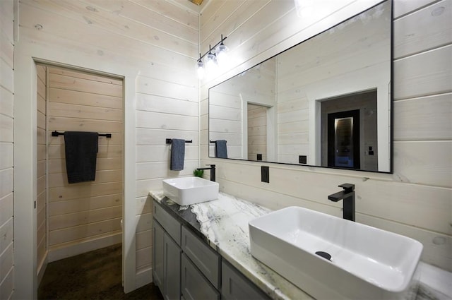 bathroom with vanity and wooden walls