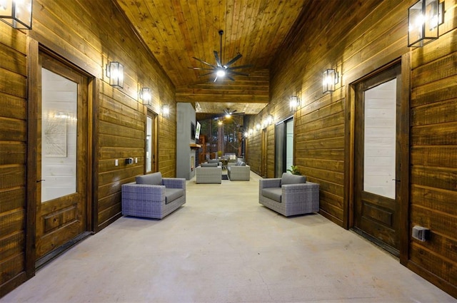 hallway with high vaulted ceiling, wood ceiling, and wood walls