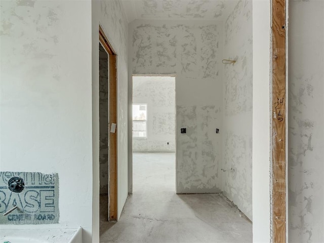 hallway with unfinished concrete floors