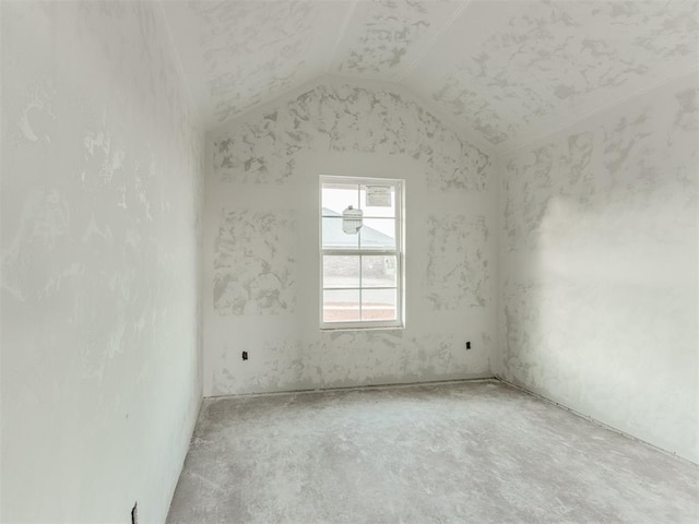 spare room with vaulted ceiling