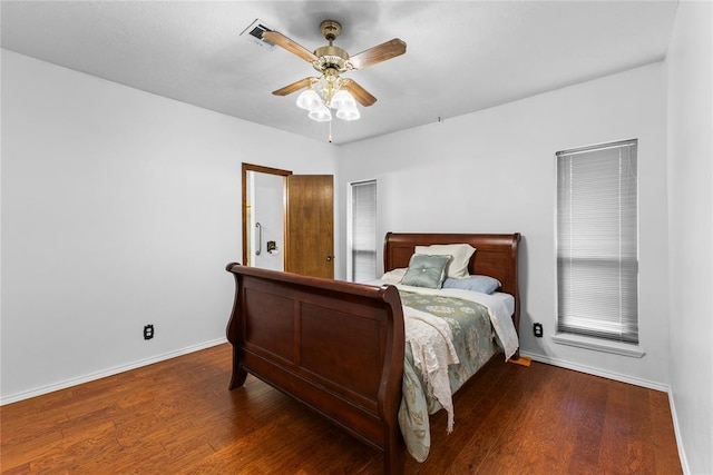 bedroom featuring wood finished floors, ceiling fan, baseboards, and visible vents