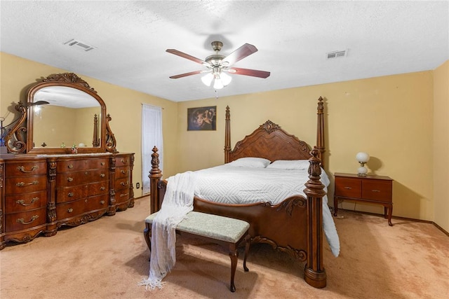 bedroom with visible vents, ceiling fan, a textured ceiling, and carpet floors