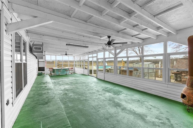unfurnished sunroom featuring a water view and ceiling fan