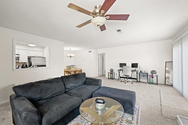 carpeted living room with ornamental molding, ceiling fan with notable chandelier, and a textured ceiling