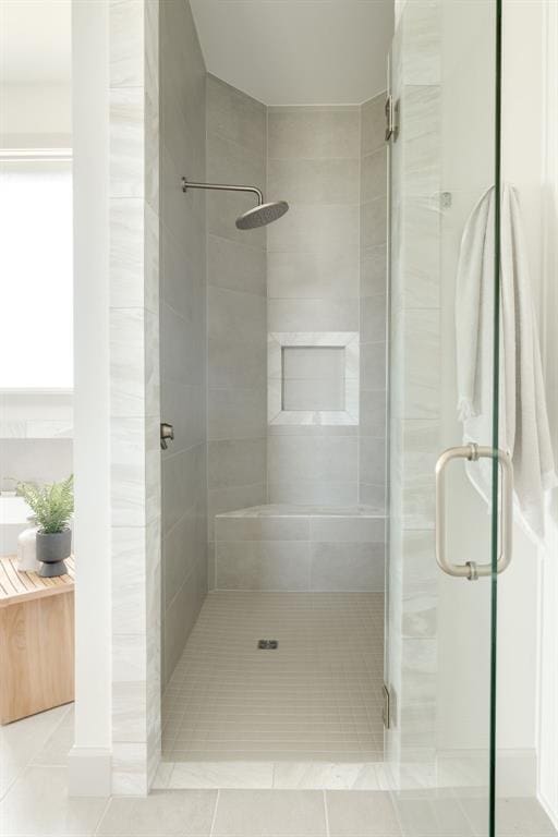 bathroom featuring tile patterned floors and a stall shower
