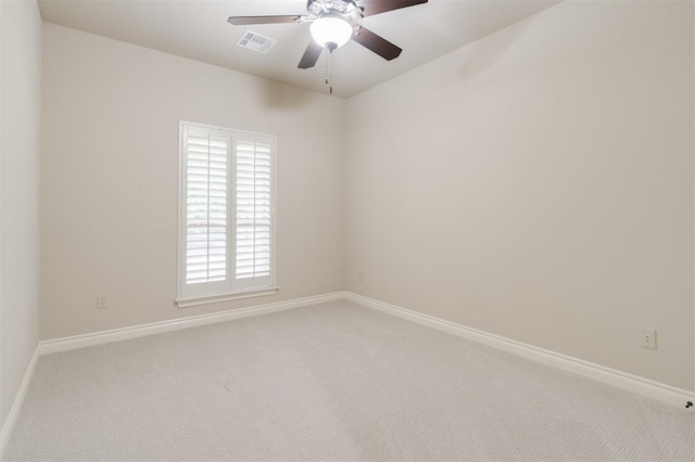 empty room with visible vents, ceiling fan, baseboards, and light colored carpet