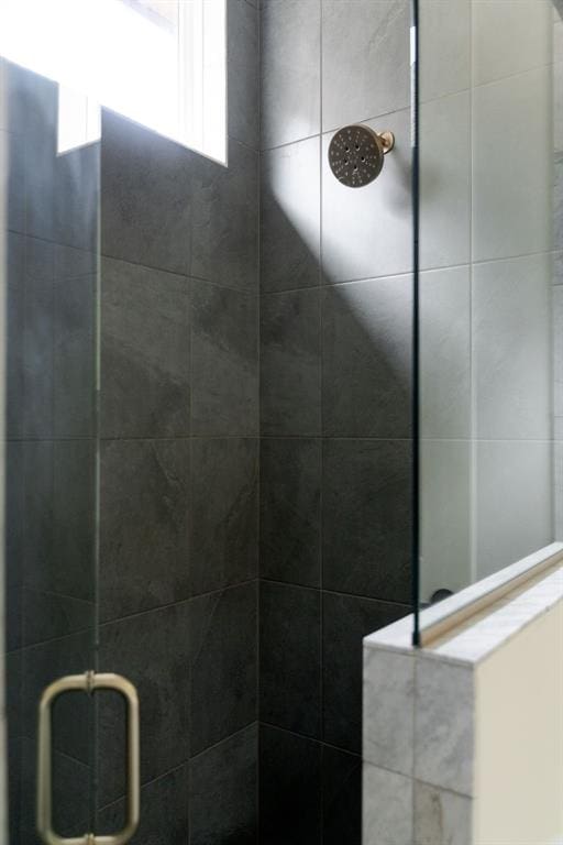 bathroom with tiled shower