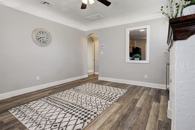 unfurnished room featuring dark hardwood / wood-style flooring and ceiling fan