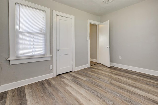 unfurnished bedroom with light wood-type flooring