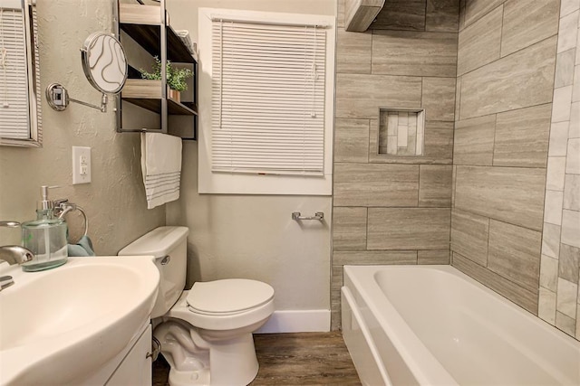 bathroom with hardwood / wood-style floors, sink, and toilet