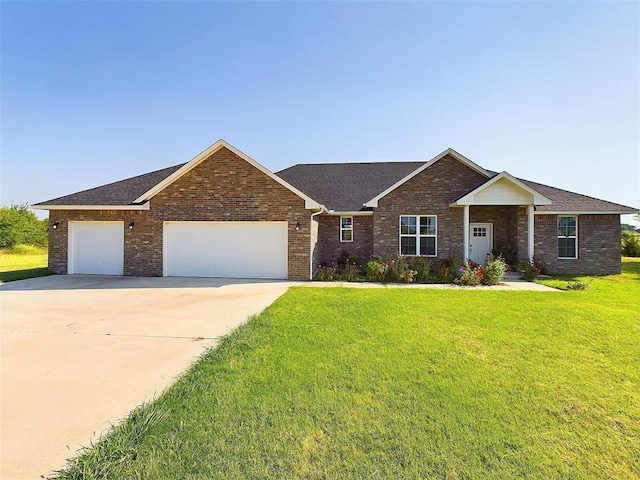 view of front of property with a garage and a front yard