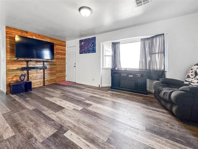 living room featuring wood-type flooring and wood walls