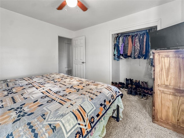 bedroom with light carpet, ceiling fan, and a closet