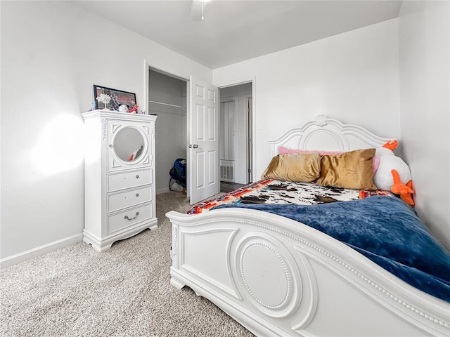 bedroom with light colored carpet and a closet