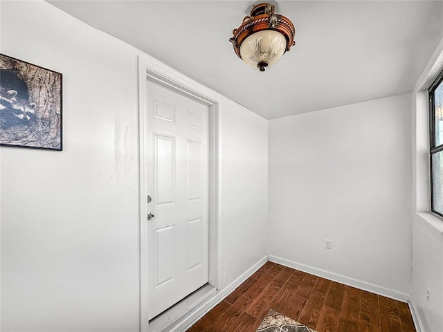 unfurnished room with dark hardwood / wood-style flooring